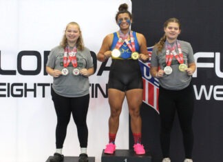 a group of women standing on top of a podium