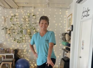 a woman standing in a room with balloons
