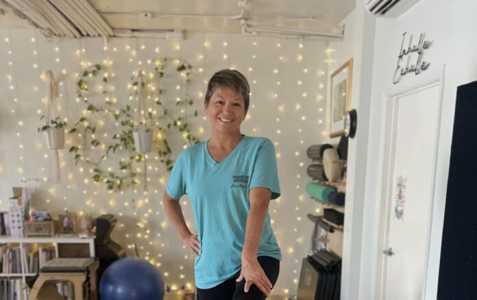 a woman standing in a room with balloons