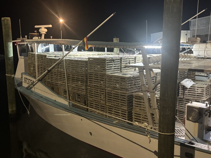 a boat docked at a dock at night