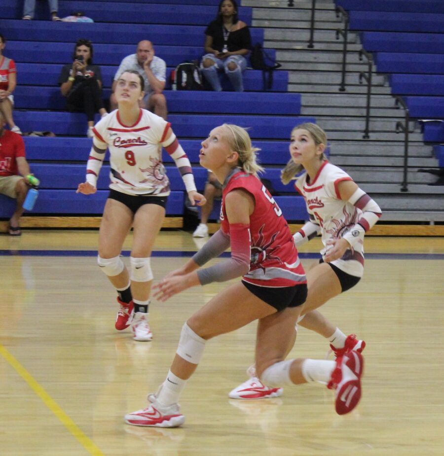 a group of young women playing a game of volleyball