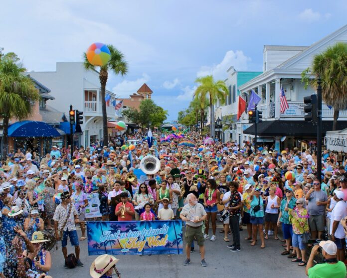 Just a Few Friends Parade 2024 Large a large group of people standing in the middle of a street