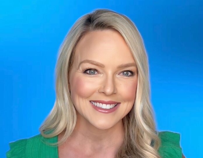 a woman with blonde hair and a green top