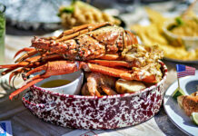 a table topped with plates and bowls of food