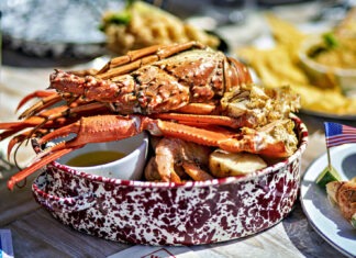 a table topped with plates and bowls of food
