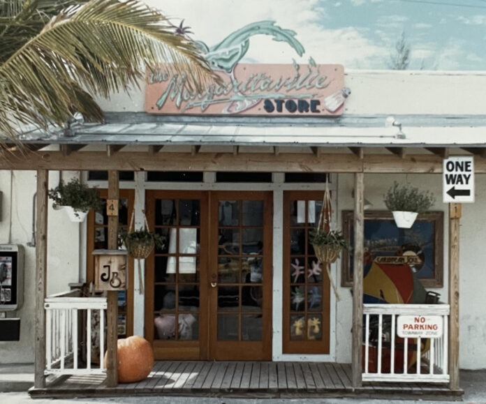 a store front with a palm tree in front of it