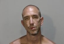 a mug shot of a man without a shirt