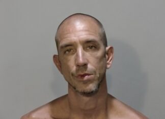 a mug shot of a man without a shirt