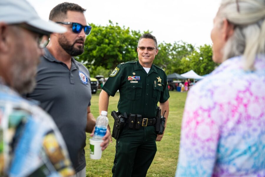 a police officer talking to a group of people