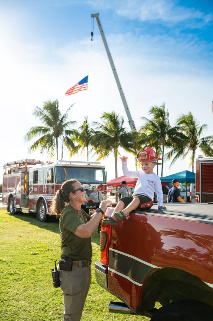 a woman holding a child on the back of a truck