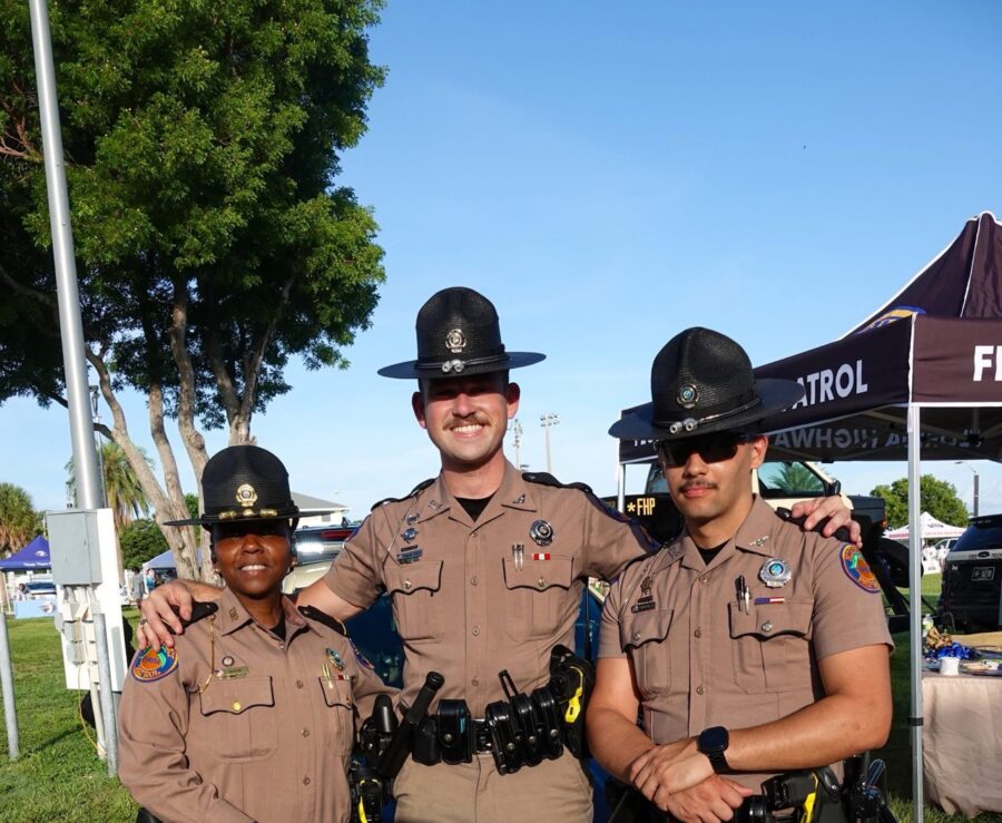 three police officers are posing for a picture