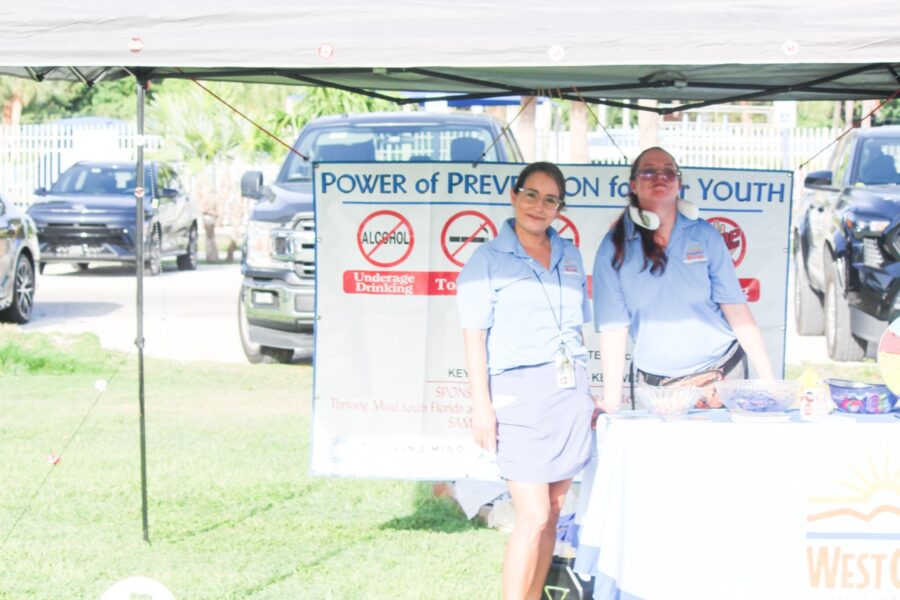 a couple of women standing under a tent
