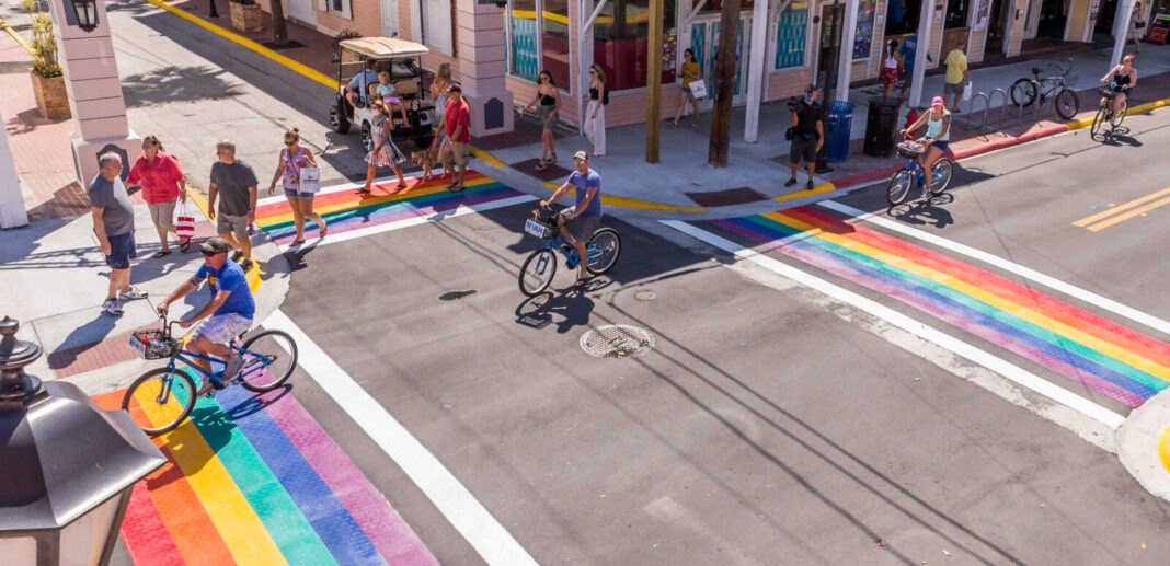 a group of people riding bikes down a street