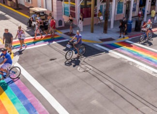 a group of people riding bikes down a street