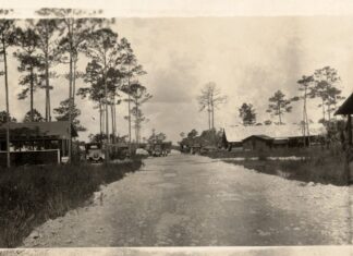 a black and white photo of a dirt road