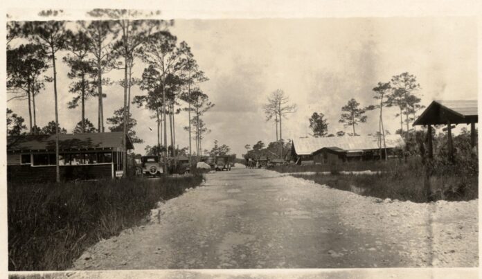 a black and white photo of a dirt road