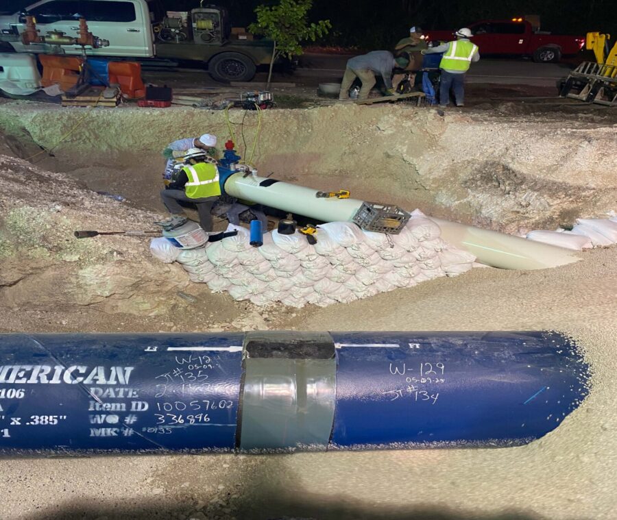 a pipe laying on top of a pile of sand