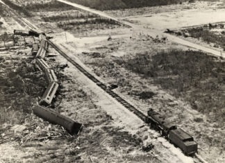 a black and white photo of a train on tracks