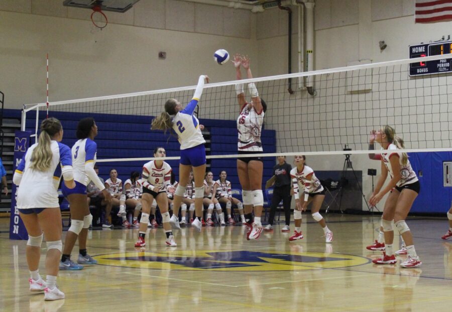 a group of young women playing a game of volleyball