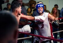 a man in a boxing ring with a punching glove