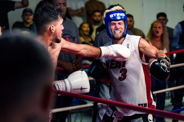 a man in a boxing ring with a punching glove