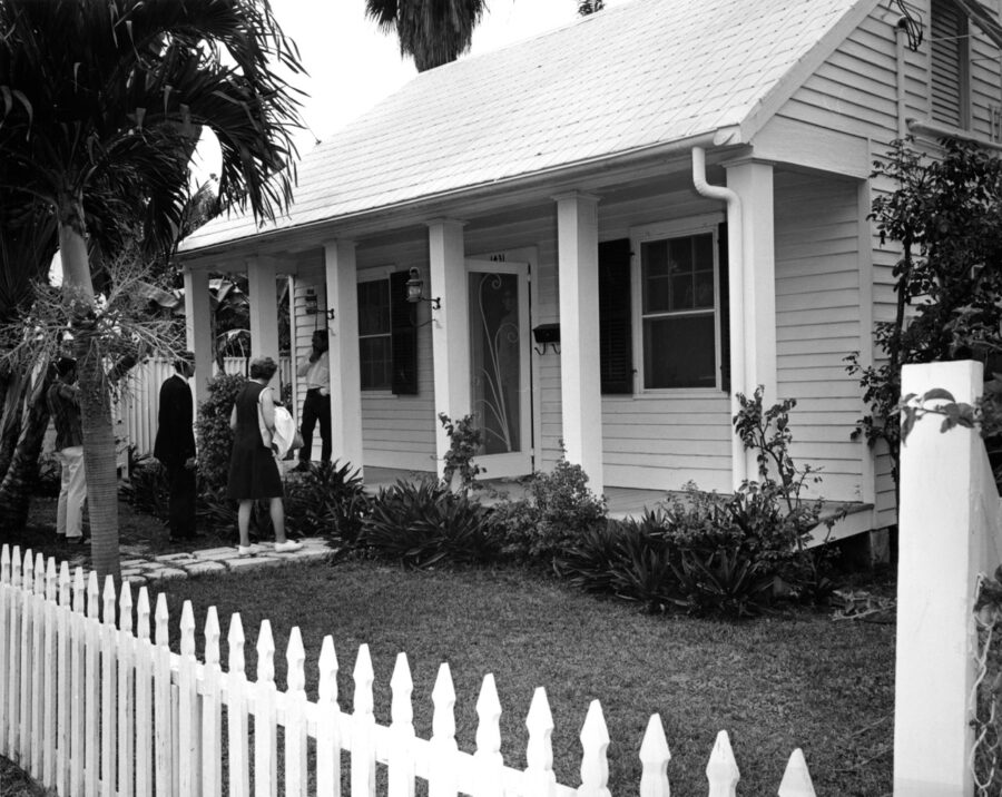 a white house with a white picket fence