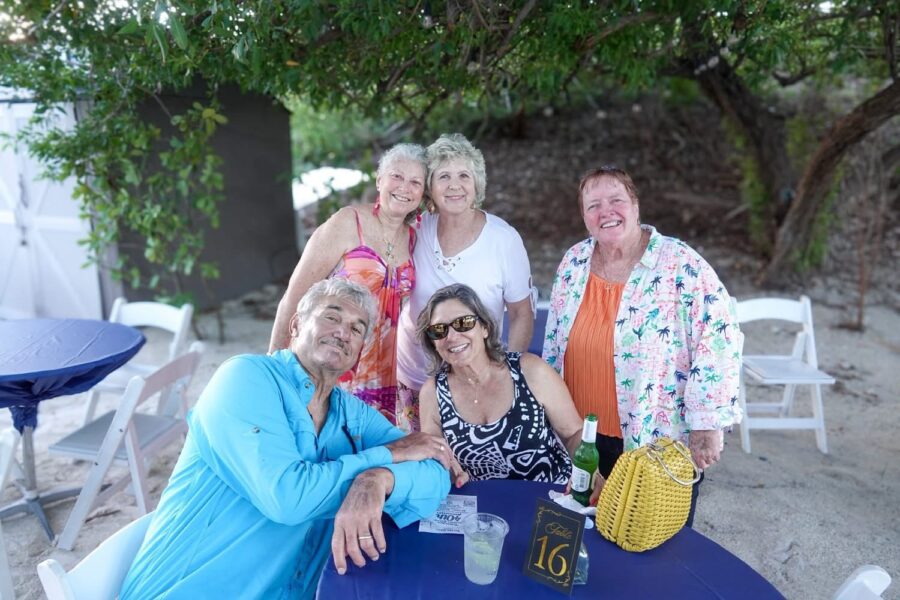 a group of people standing around a table
