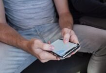 a man sitting on a couch using a cell phone
