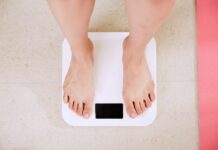 a woman standing on a bathroom scale