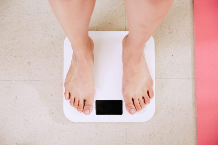 a woman standing on a bathroom scale