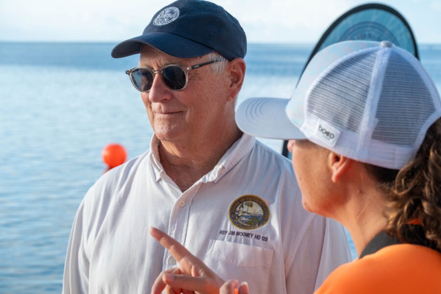 a couple of people that are standing near the water