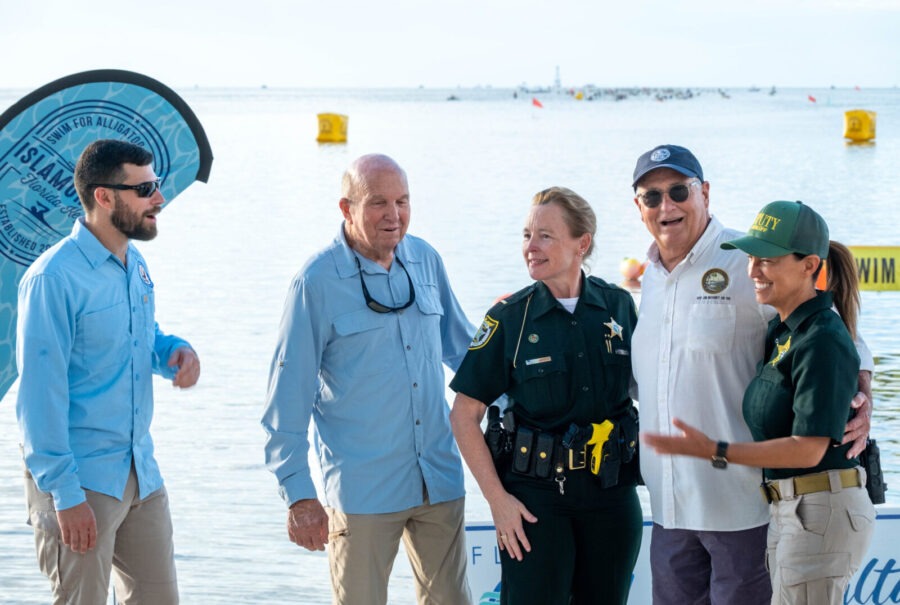 a group of people standing next to a body of water
