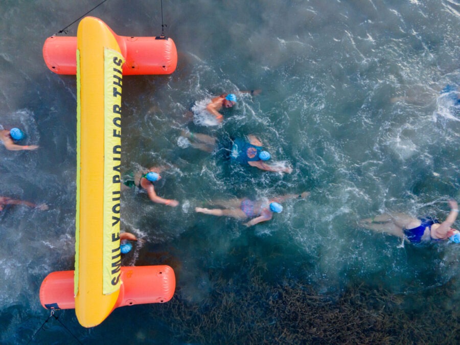 a group of people swimming in the ocean
