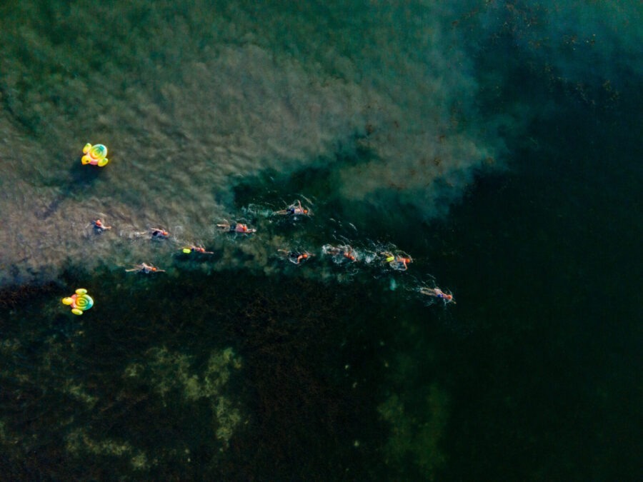 a group of people in kayaks paddling on a large body of water