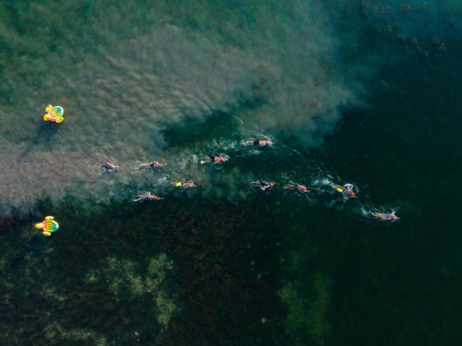 a group of people in kayaks paddling on a large body of water