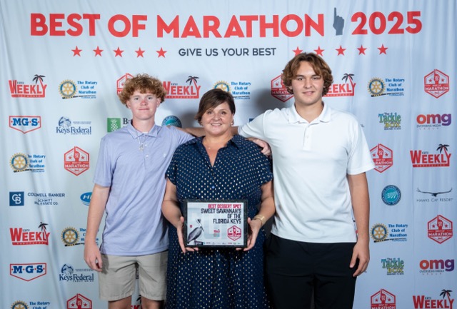 a group of people standing next to each other on a red carpet