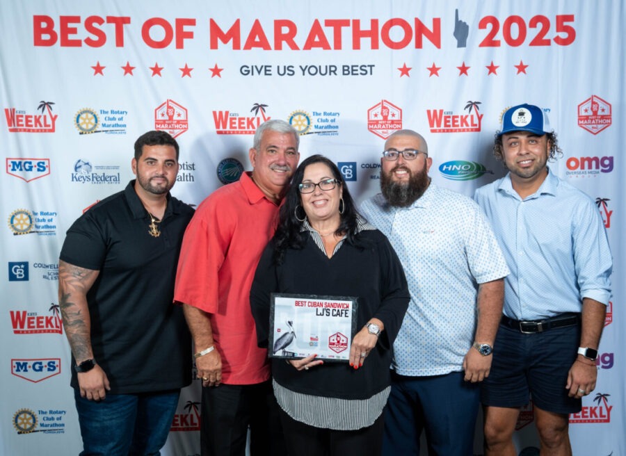 a group of people standing in front of a banner