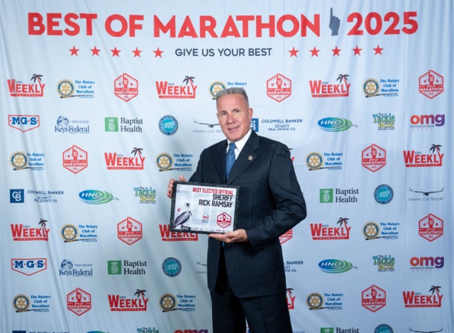 a man in a suit and tie holding a plaque