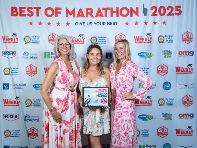 a group of women standing next to each other on a red carpet