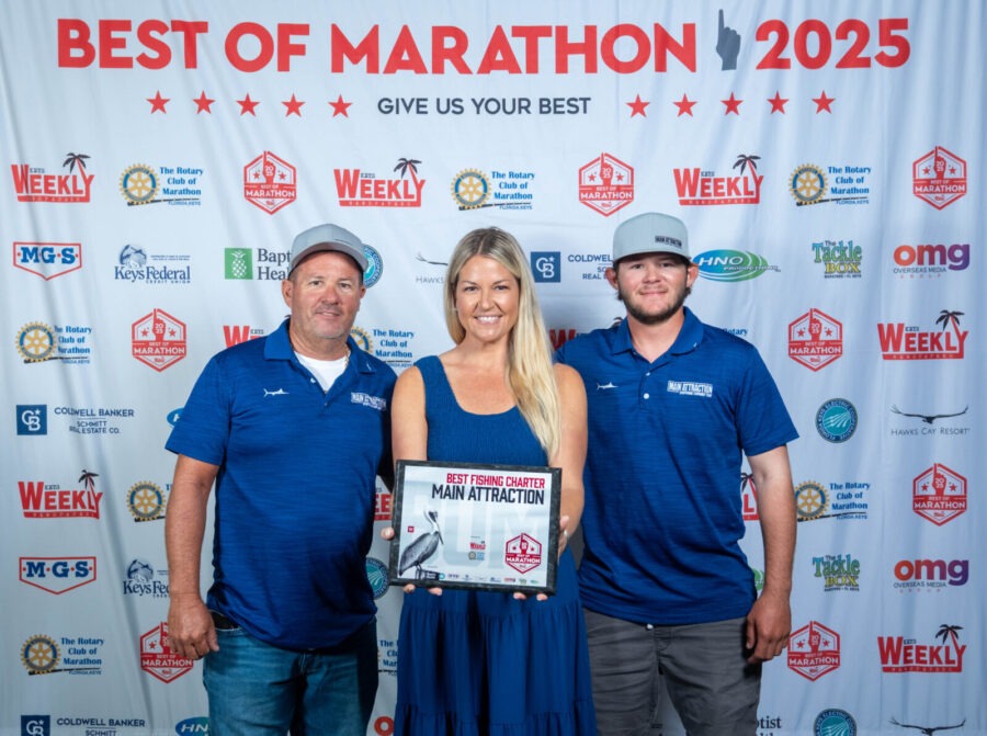 three men and a woman standing in front of a banner