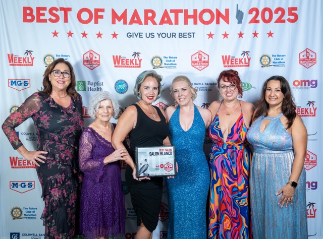a group of women standing next to each other on a red carpet