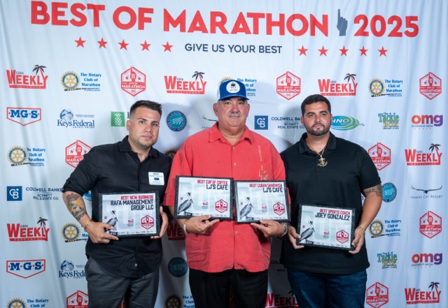 a group of men standing next to each other on a red carpet