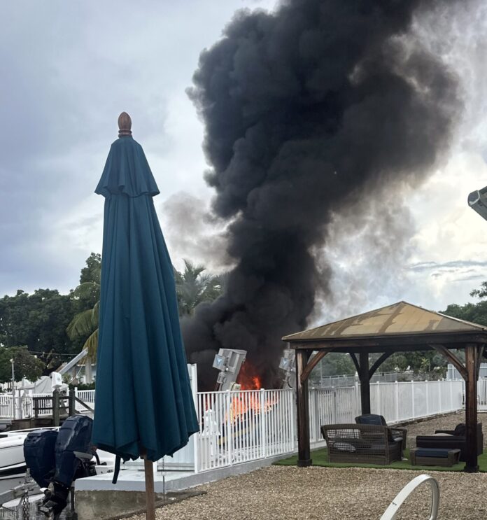 092325 boat fire a large black cloud of smoke billows from a building