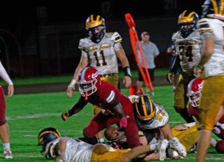 a group of football players playing a game of football