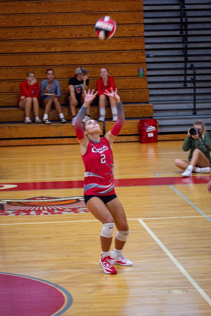 a volleyball player jumps to hit the ball