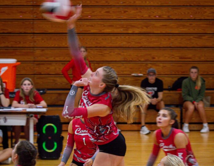 a group of girls playing a game of volleyball