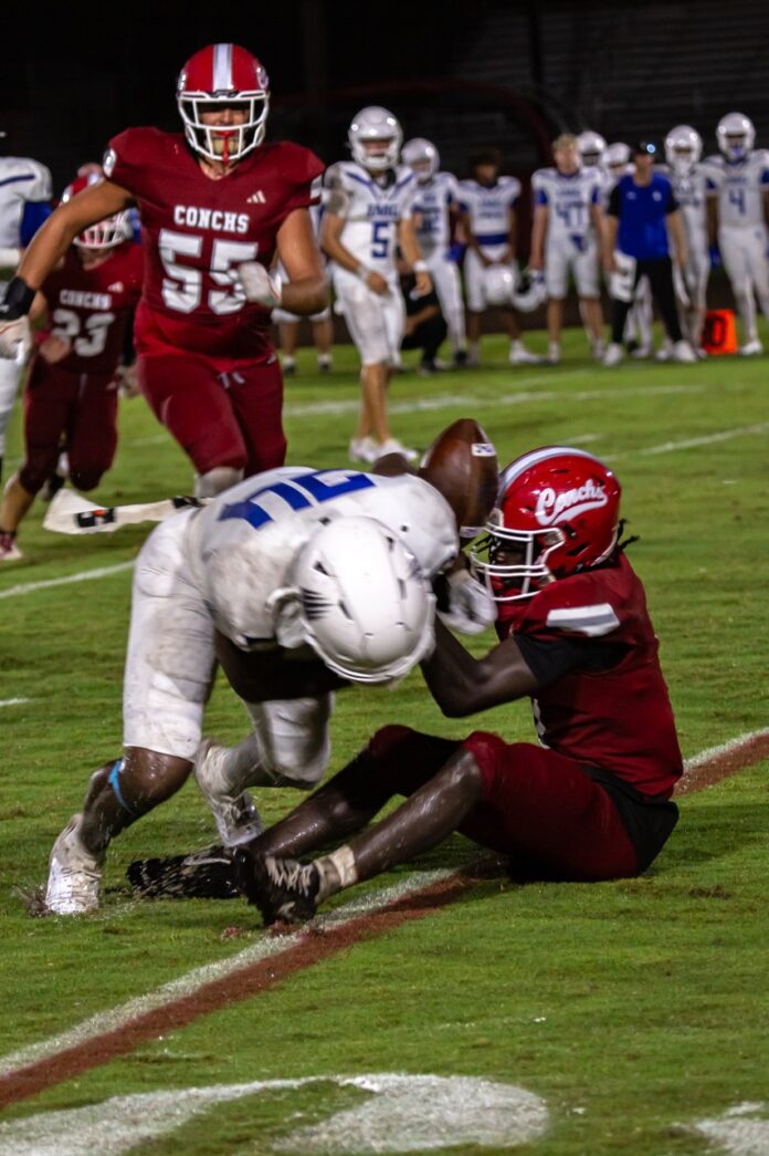 a football player is being tackled by another player
