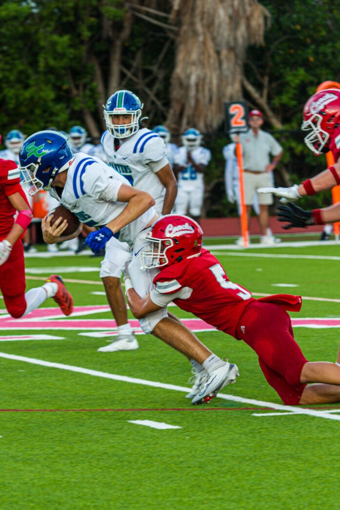 a football player running with the ball during a game