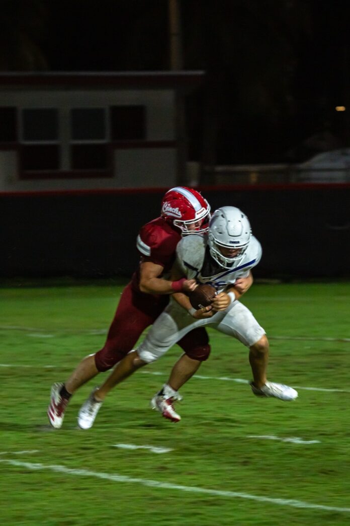 a football player is being tackled by another player