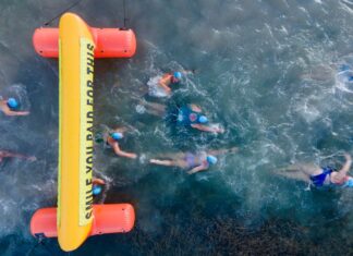 a group of people swimming in the ocean